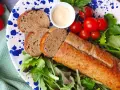 Un gustoso polpettone di tonno affettato, servito con pomodorini, insalata fresca e una ciotolina di maionese.