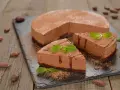 Deliziosa bavarese al cioccolato, cosparsa di cacao e decorata con menta fresca. Due fette sono già state servite.