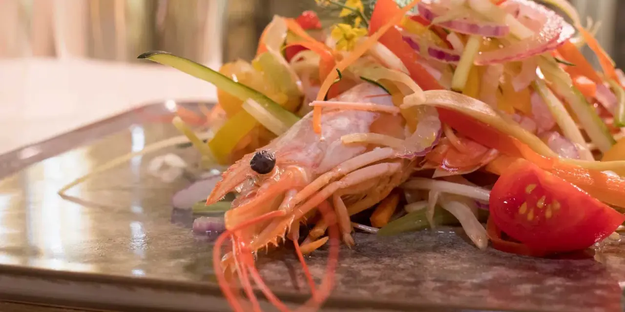 Gambero rosa su letto di verdure fresche, un'elegante catalana di crostacei.