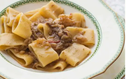 Paccheri alla genovese, un piatto ricco e saporito, con pasta fresca e un sugo di cipolle caramellate e carne.