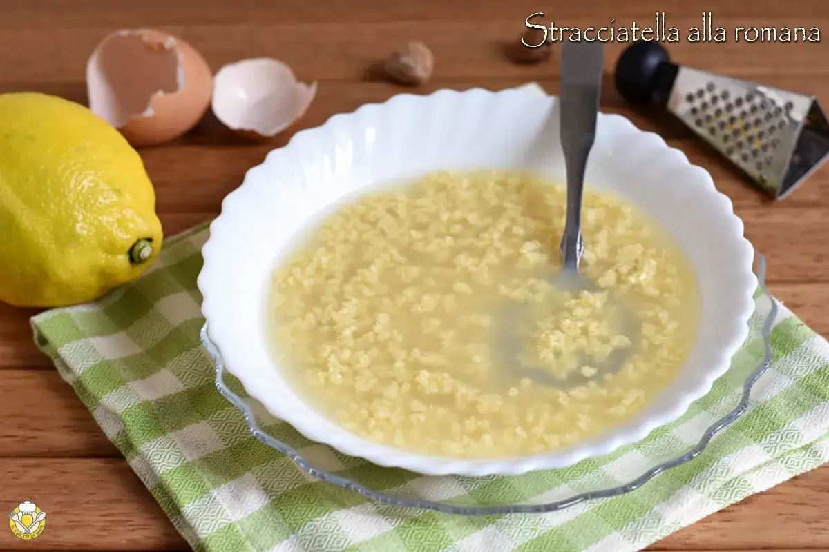 Stracciatella alla romana: un piatto caldo e confortante, con uova, parmigiano e brodo. Ingredienti freschi come limone e gusci d'uovo completano la scena.